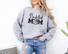 Basketball mom sweatshirt with a cute cursive font and a college text font.  Great apparel for basketball games.