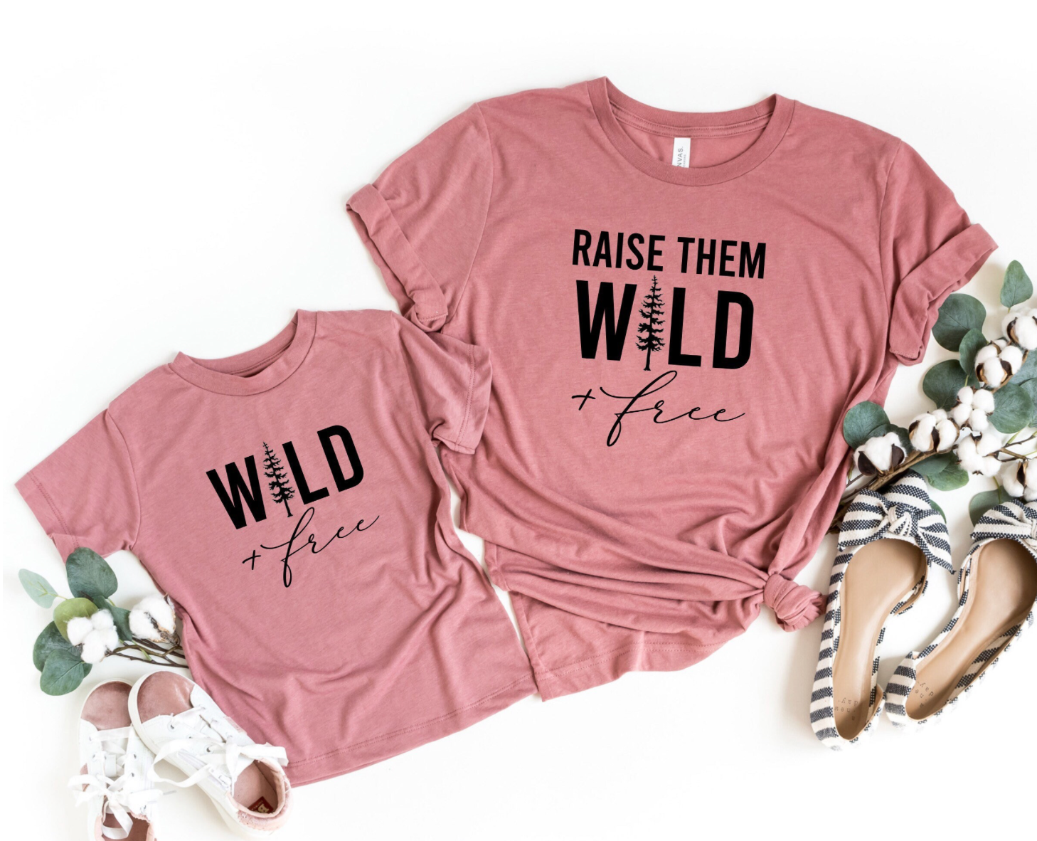 Matching mom and me shirts that say raise them wild and free and matching shirt that says wild and free.  the shirt color is mauve and the designs are black.