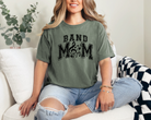 band mom tshirt in the color moss.  The design is black and meant to look slightly faded in sports and where the O would be in mom its replaced with music symbols.