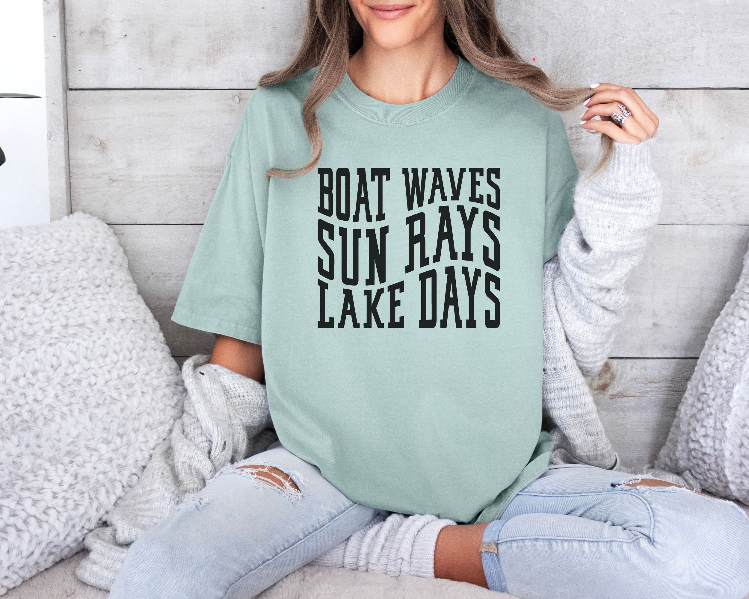 lake shirt that says boat waves sun rays lake days in a wavy text.  Shirt color is bay and design in black