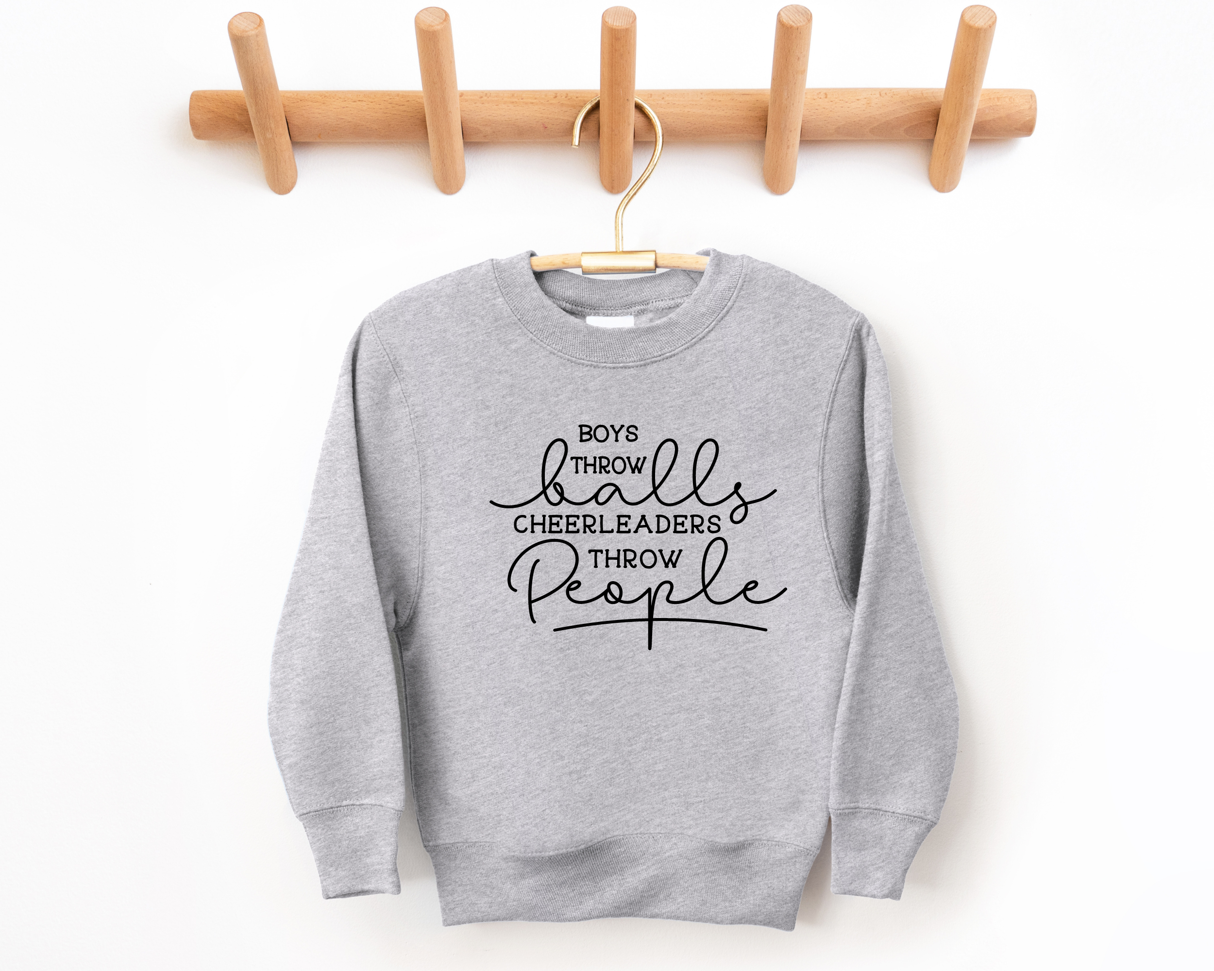 Funny cheer sweatshirt that says boys throw balls cheerleaders throw people in gray
