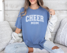 Cheer mom shirt in a college outline text in the color blue with white design.
