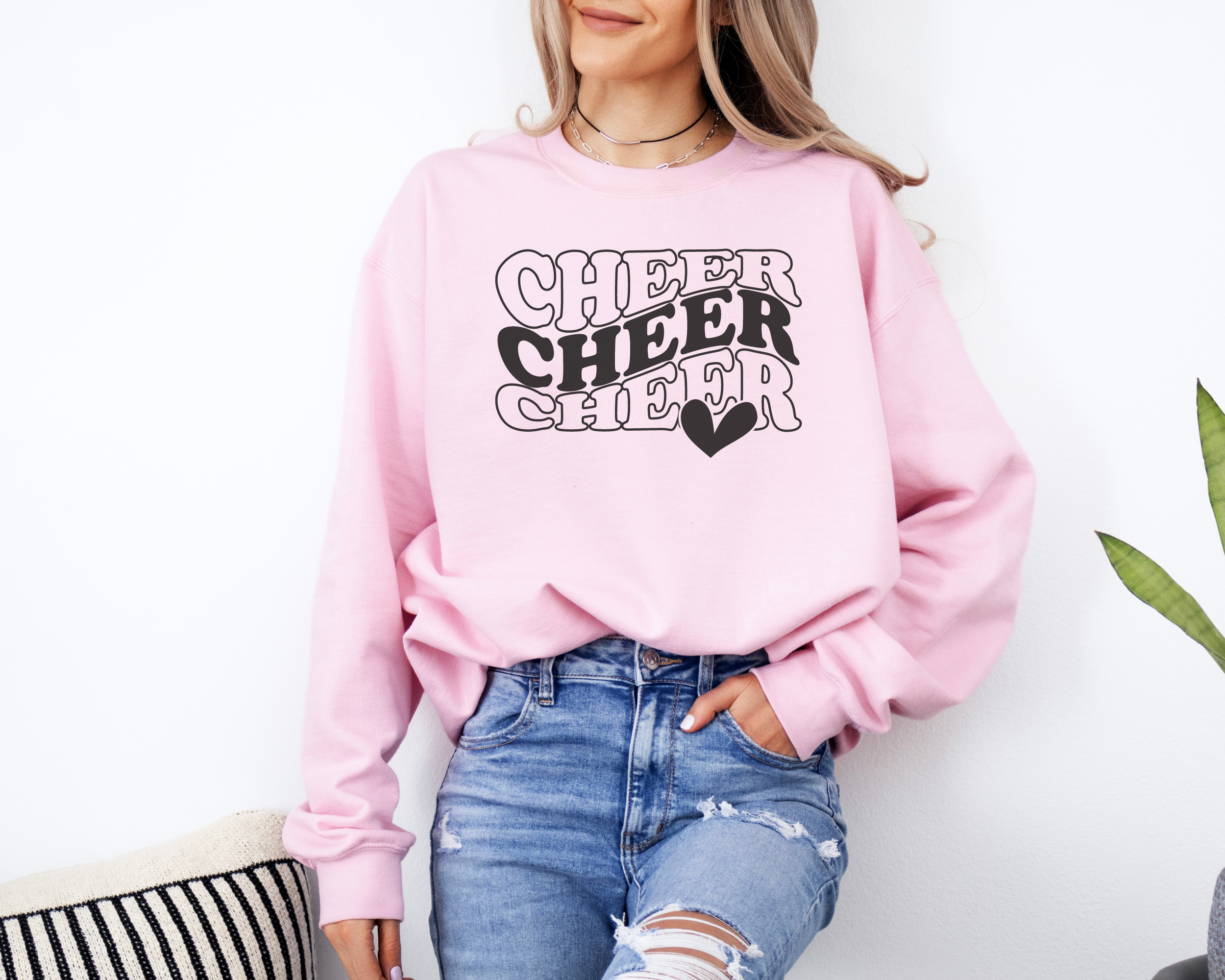 Pink Cheer sweatshirt in in a wavy stacked text with a heart.