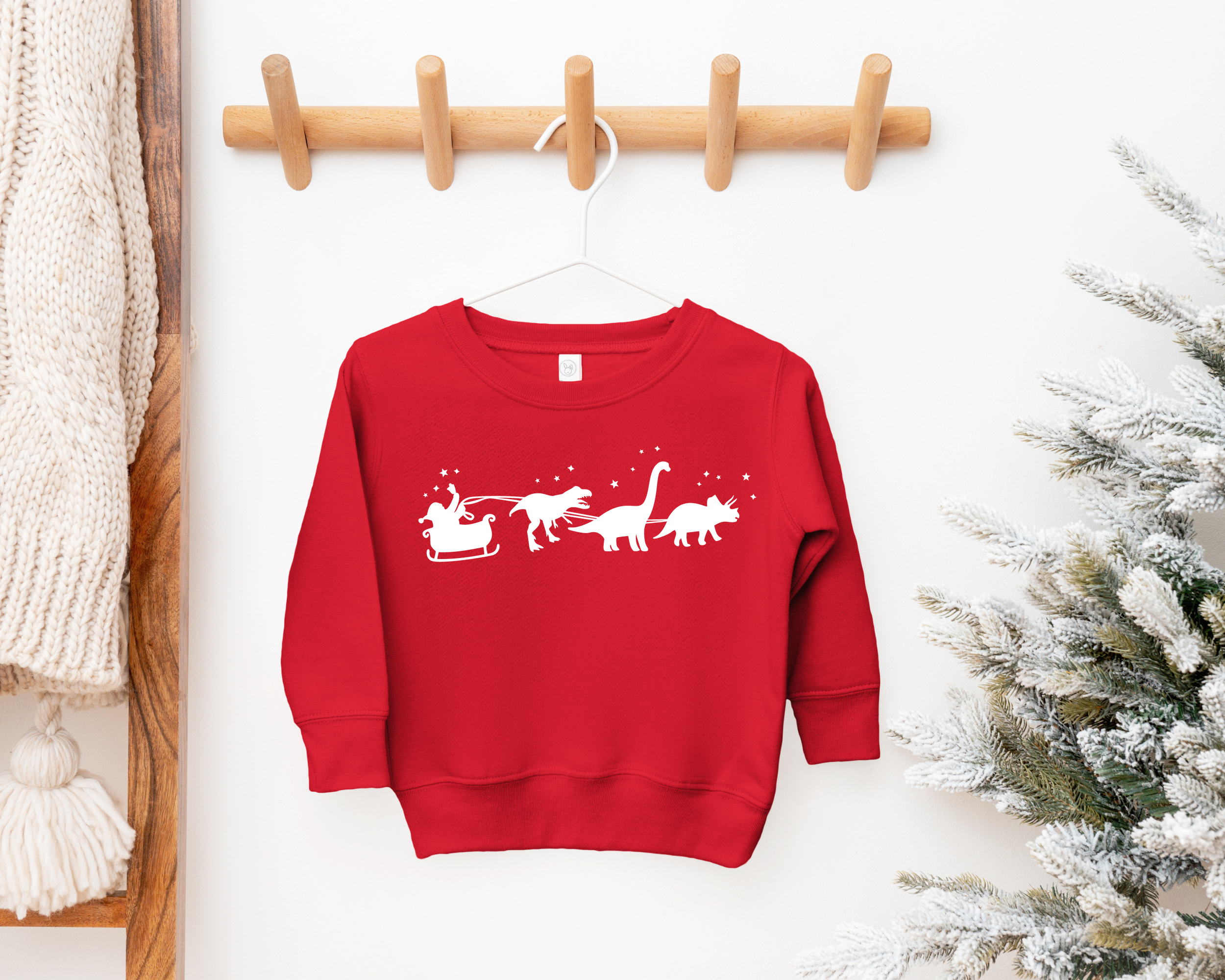 Toddler christmas sweatshirt with a santa sleigh and dinosaurs pulling the sleigh.